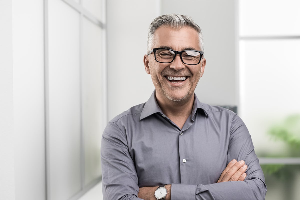 Man with arms crossed smiling image